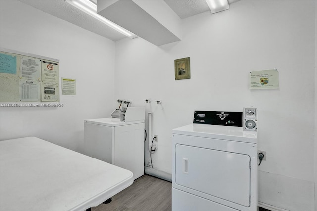 1108 Bahama Bnd Unit B1, Coconut Creek, FL 33066 - washroom featuring washing machine and clothes dryer and light wood-style flooring