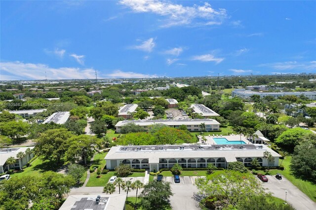 1108 Bahama Bnd Unit B1, Coconut Creek, FL 33066 - drone / aerial view of a pool area and a tree filled landscape