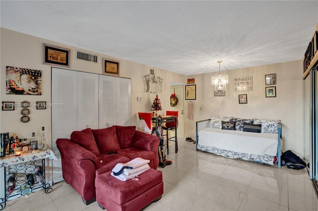 4222 Inverrary Blvd Unit 4213, Lauderhill, FL 33319 - living room with a chandelier, a textured ceiling, and tile patterned flooring
