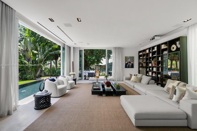 4700 N Meridian Ave, Miami Beach, FL 33140 - living area featuring healthy amount of natural light, wood finished floors, and expansive windows