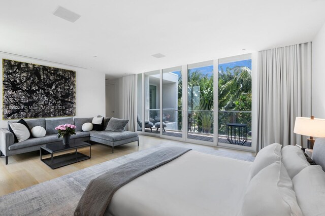 4700 N Meridian Ave, Miami Beach, FL 33140 - bedroom featuring a wall of windows, wood finished floors, and access to exterior