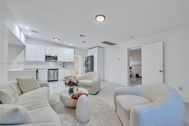 13550 NW 5th Ave, North Miami, FL 33168 - living room featuring light marble finish flooring, baseboards, recessed lighting, and vaulted ceiling