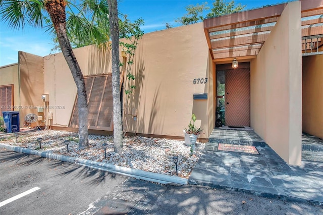 6703 Kingsmoor Way, Miami Lakes, FL 33014 - entrance to property featuring stucco siding and a pergola