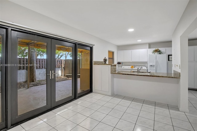 6703 Kingsmoor Way, Miami Lakes, FL 33014 - kitchen featuring white appliances, dark stone counters, white cabinetry, light tile patterned floors, and recessed lighting