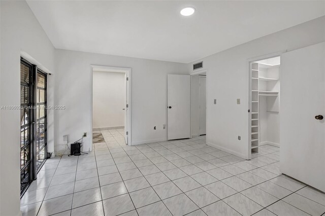 6703 Kingsmoor Way, Miami Lakes, FL 33014 - unfurnished bedroom featuring a spacious closet, light tile patterned floors, baseboards, and a closet