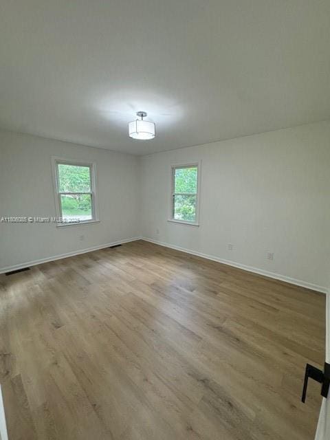902 Vickie Dr, ,, NC 27511 - unfurnished room with healthy amount of natural light and wood finished floors