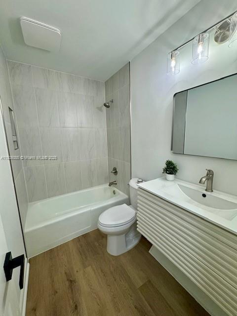 902 Vickie Dr, ,, NC 27511 - full bathroom featuring wood finished floors, washtub / shower combination, and vanity