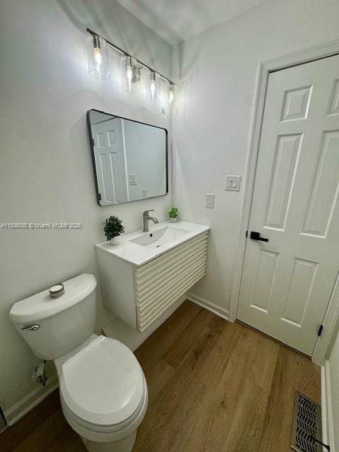 902 Vickie Dr, ,, NC 27511 - bathroom with wood finished floors, toilet, vanity, and baseboards