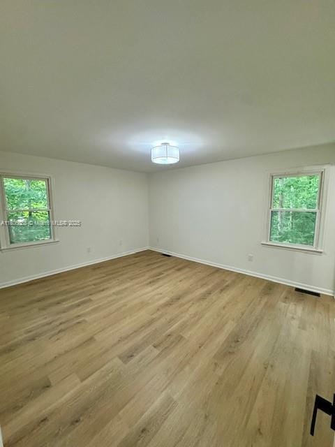 902 Vickie Dr, ,, NC 27511 - unfurnished room featuring healthy amount of natural light, light wood-type flooring, and baseboards