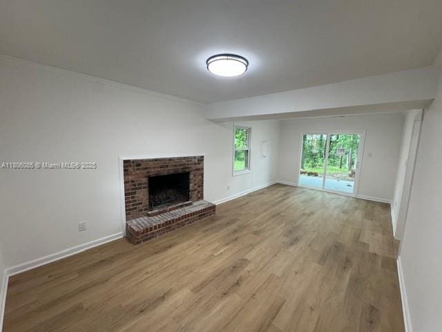 902 Vickie Dr, ,, NC 27511 - unfurnished living room featuring wood finished floors and a brick fireplace