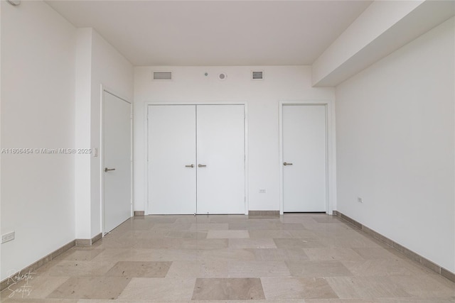 88 SW 7th St Unit 2504, Miami, FL 33130 - unfurnished bedroom featuring baseboards and a closet