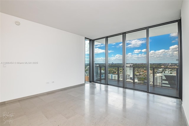 88 SW 7th St Unit 2504, Miami, FL 33130 - spare room featuring expansive windows, baseboards, tile patterned floors, and a view of city