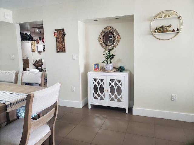 1775 Washington Ave Unit 4A, Miami Beach, FL 33139 - dining room featuring baseboards and dark tile patterned flooring