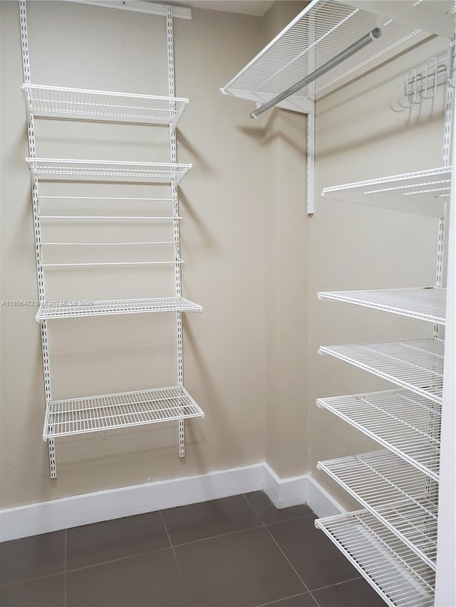 1775 Washington Ave Unit 4A, Miami Beach, FL 33139 - walk in closet featuring tile patterned floors