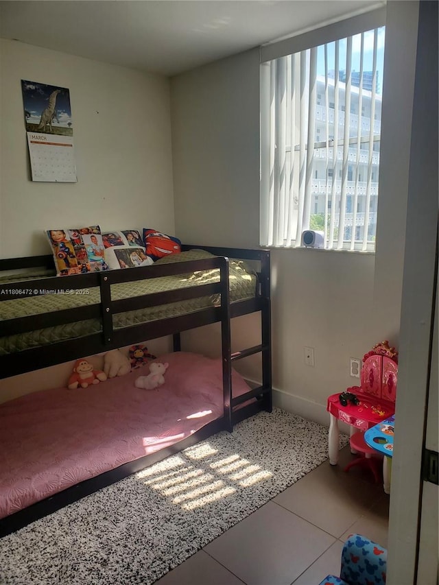 1775 Washington Ave Unit 4A, Miami Beach, FL 33139 - bedroom featuring baseboards and tile patterned floors