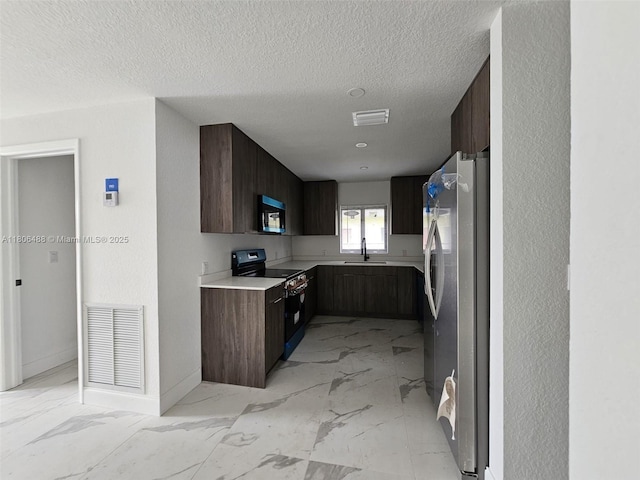 714 NW 4th Ave, Pompano Beach, FL 33060 - kitchen featuring freestanding refrigerator, a sink, light marble finish flooring, black electric range, and modern cabinets