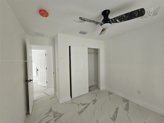 714 NW 4th Ave, Pompano Beach, FL 33060 - unfurnished bedroom with light marble finish floors, baseboards, a closet, and a ceiling fan