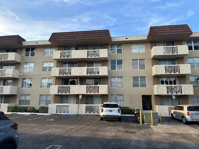 1800 Sans Souci Blvd Unit 115, North Miami, FL 33181 - view of apartment building / complex with uncovered parking