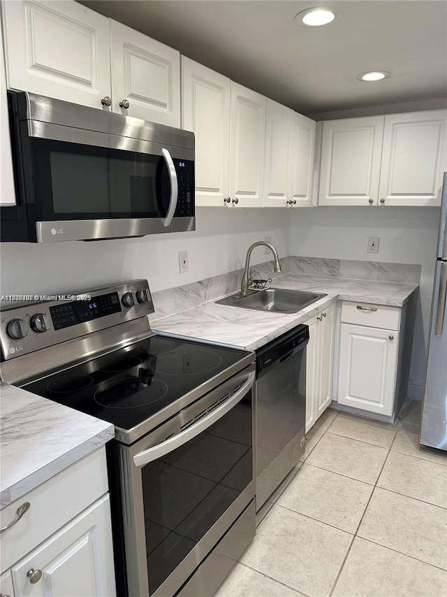 1800 Sans Souci Blvd Unit 115, North Miami, FL 33181 - kitchen with stainless steel appliances, a sink, white cabinetry, light countertops, and recessed lighting