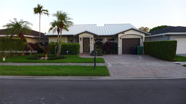 14430 SW 108th St, Miami, FL 33186 - single story home with stucco siding, decorative driveway, a garage, and metal roof