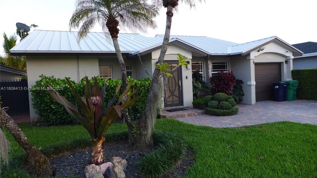 14430 SW 108th St, Miami, FL 33186 - ranch-style home with stucco siding, an attached garage, decorative driveway, and metal roof