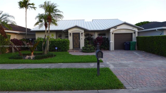 14430 SW 108th St, Miami, FL 33186 - ranch-style home with stucco siding, decorative driveway, an attached garage, and metal roof