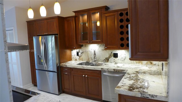 14430 SW 108th St, Miami, FL 33186 - kitchen with appliances with stainless steel finishes, a sink, decorative backsplash, glass insert cabinets, and pendant lighting
