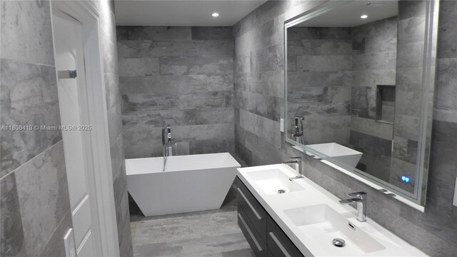 14430 SW 108th St, Miami, FL 33186 - bathroom featuring tile walls, a freestanding bath, and double vanity