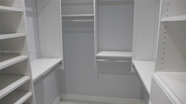 14430 SW 108th St, Miami, FL 33186 - walk in closet featuring marble look tile flooring