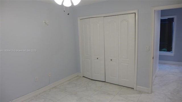 14430 SW 108th St, Miami, FL 33186 - unfurnished bedroom featuring a closet, light marble finish floors, and baseboards