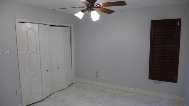 14430 SW 108th St, Miami, FL 33186 - unfurnished bedroom featuring light marble finish floors, a closet, baseboards, and ceiling fan