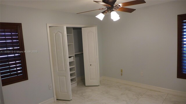 14430 SW 108th St, Miami, FL 33186 - unfurnished bedroom with light marble finish floors, baseboards, a closet, and ceiling fan