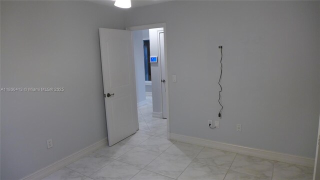 14430 SW 108th St, Miami, FL 33186 - empty room featuring light marble finish flooring and baseboards