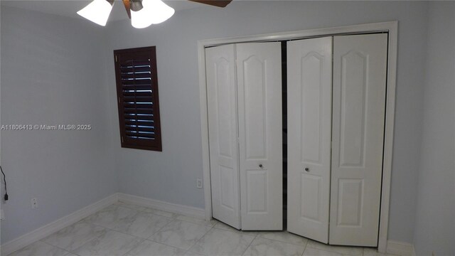 14430 SW 108th St, Miami, FL 33186 - unfurnished bedroom featuring baseboards, a closet, light marble finish floors, and ceiling fan
