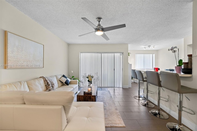 2640 S University Dr Unit 118, Davie, FL 33328 - living room featuring a ceiling fan, a textured ceiling, and baseboards