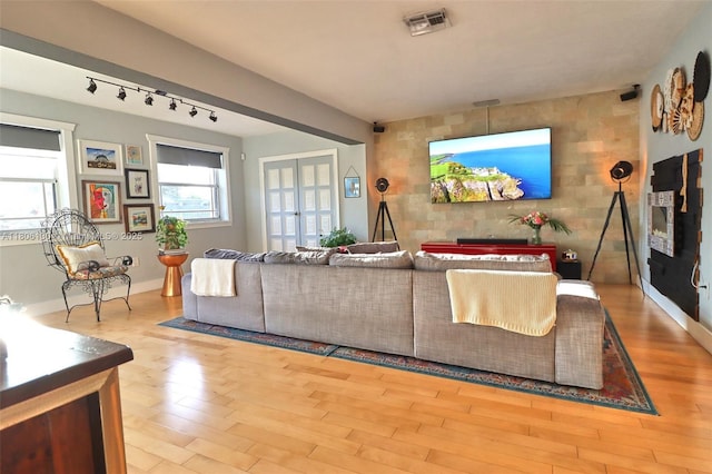 101 NE 9th Ave, Hialeah, FL 33010 - living room with wood finished floors, track lighting, and baseboards