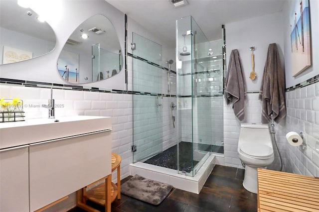 101 NE 9th Ave, Hialeah, FL 33010 - full bathroom with tile walls, a shower stall, toilet, vanity, and tile patterned floors