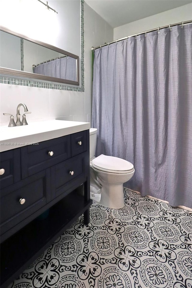 101 NE 9th Ave, Hialeah, FL 33010 - bathroom featuring toilet, vanity, decorative backsplash, and tile patterned flooring