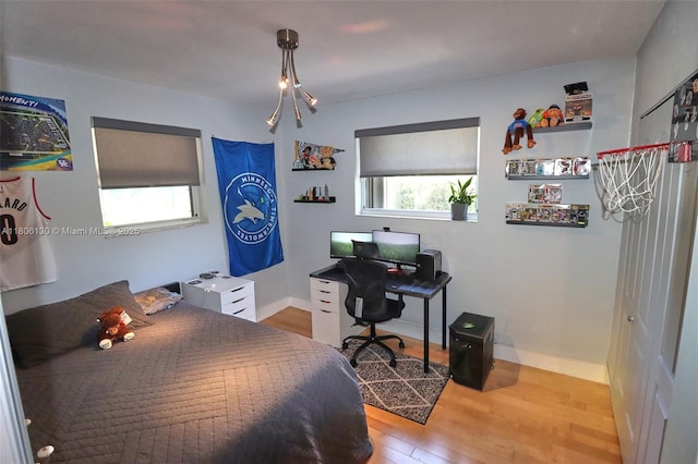 101 NE 9th Ave, Hialeah, FL 33010 - bedroom with wood finished floors, an office area, and baseboards