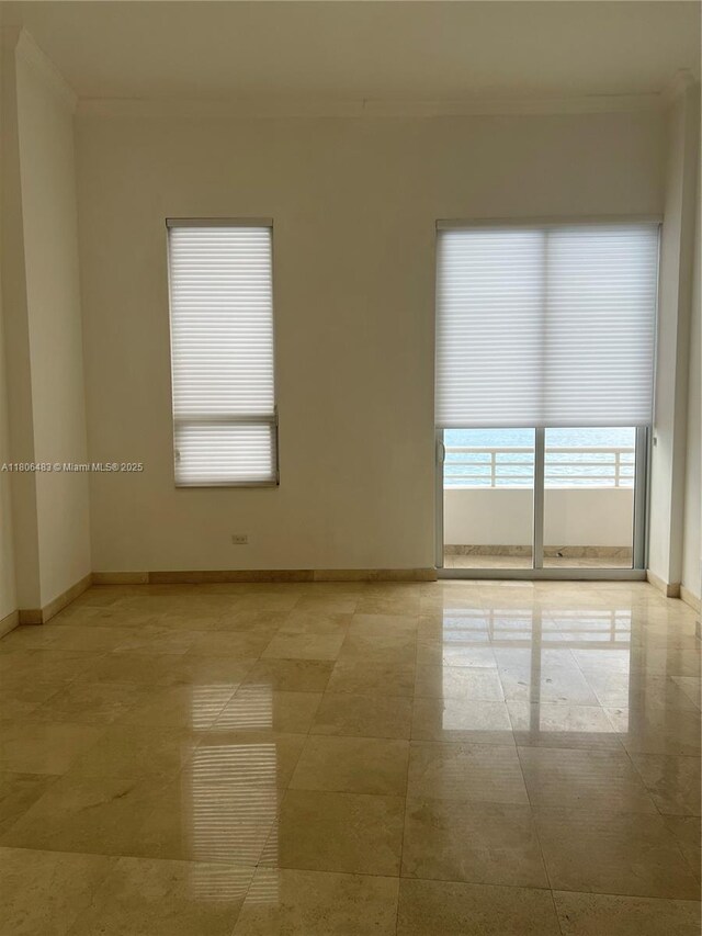 808 Brickell Key Dr Unit 404, Miami, FL 33131 - spare room featuring ornamental molding and baseboards