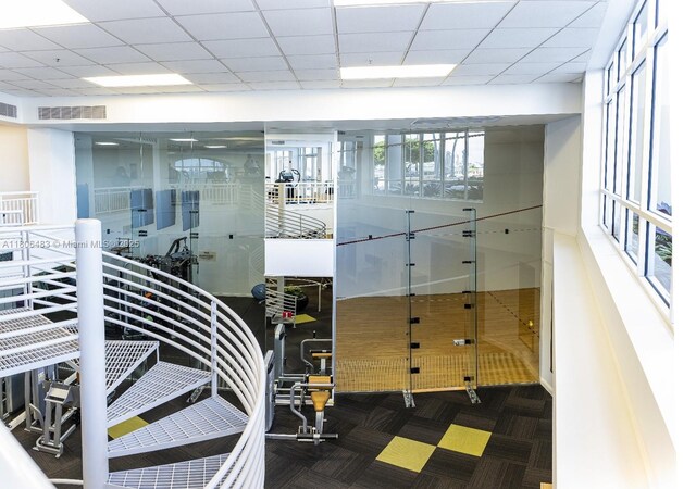 808 Brickell Key Dr Unit 404, Miami, FL 33131 - workout area featuring carpet floors and a drop ceiling