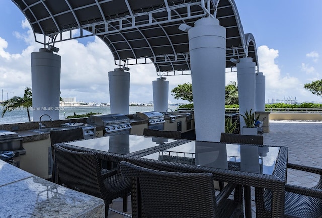 808 Brickell Key Dr Unit 404, Miami, FL 33131 - view of patio / terrace with a water view and outdoor dining space