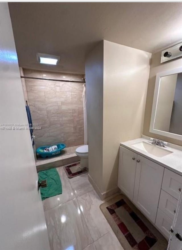 2110 SW 122nd Ct Unit 2110, Miami, FL 33175 - full bath with tiled shower, marble look tile flooring, toilet, vanity, and baseboards
