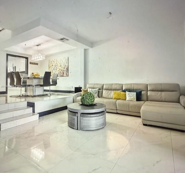 8992 Palm Tree Ln Unit 8992, Pembroke Pines, FL 33024 - living area with marble finish floors and a chandelier