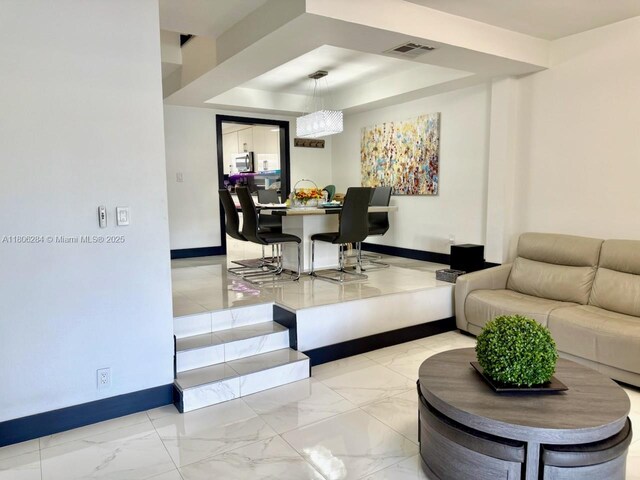 8992 Palm Tree Ln Unit 8992, Pembroke Pines, FL 33024 - kitchen with stainless steel fridge, light marble finish floors, white cabinetry, and dark countertops