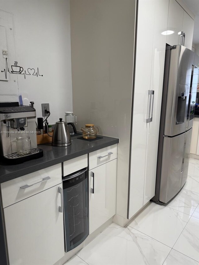8992 Palm Tree Ln Unit 8992, Pembroke Pines, FL 33024 - kitchen featuring stainless steel refrigerator with ice dispenser, wine cooler, dark countertops, and white cabinets