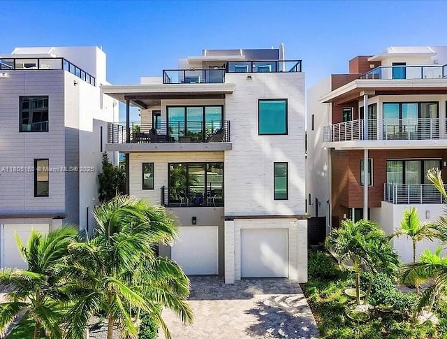 332 Balboa St, Hollywood, FL 33019 - contemporary house featuring a garage, driveway, and a balcony