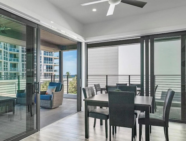 332 Balboa St, Hollywood, FL 33019 - dining area featuring ceiling fan, wood finished floors, a wall of windows, and recessed lighting
