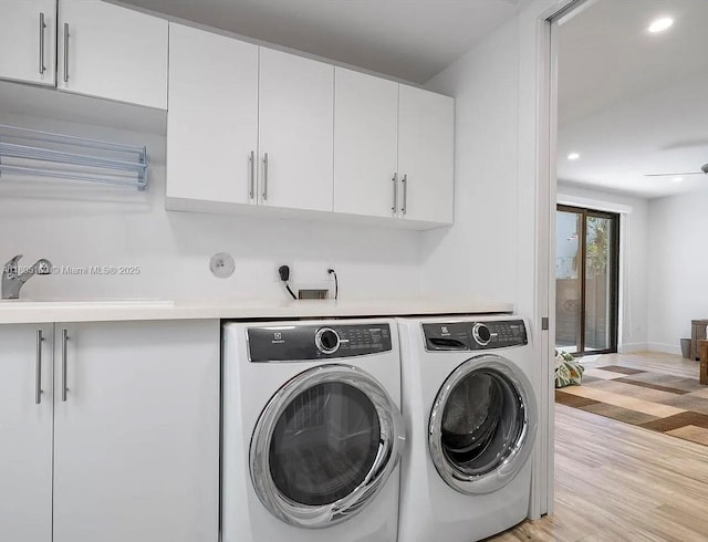 332 Balboa St, Hollywood, FL 33019 - laundry room with washer and dryer, cabinet space, light wood-style floors, and recessed lighting