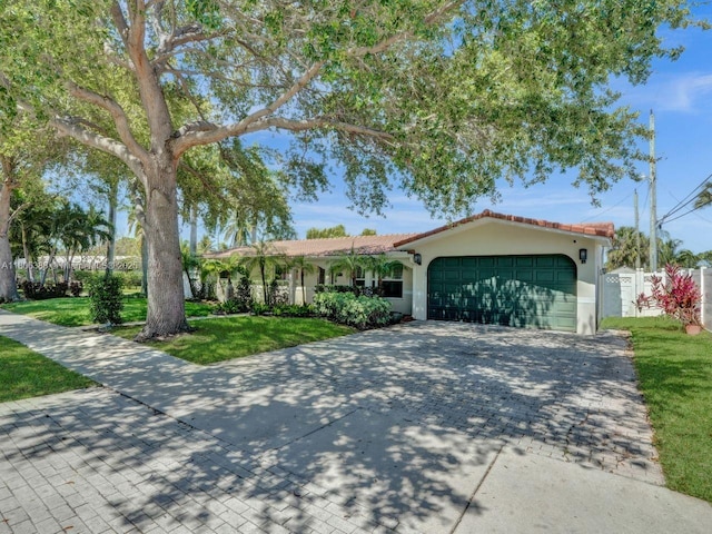 3401 NE 21st Ave, Lighthouse Point, FL 33064 - mediterranean / spanish-style home featuring stucco siding, a front yard, decorative driveway, and a garage
